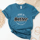 Heather Deep Teal Blue "Jesus Is Better - Once & For All" bible book of Hebrews faith-based Christian unisex t-shirt for women with a bold white and black sunburst logo style design