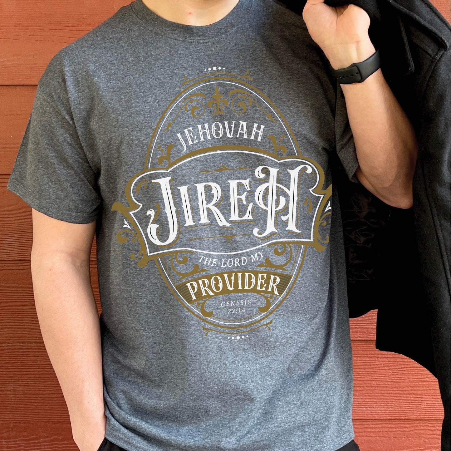 Heather Dark Gray Christian faith-based unisex t-shirt featuring a gold ornamental blackletter-style frame design with the text 'Jehovah Jireh The Lord My Provider' and 'Genesis 22:14' Bible verse, inspirational statement religious apparel for men and women