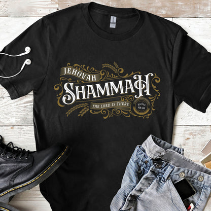 Black and gold Jehovah Shammah "The Lord Is There" Christian unisex black t-shirt from Ezekiel 38:35 vision bible verse Hebrew meaning, with vintage blackletter and ornate decorative swirl filigree design, created for men and women believers