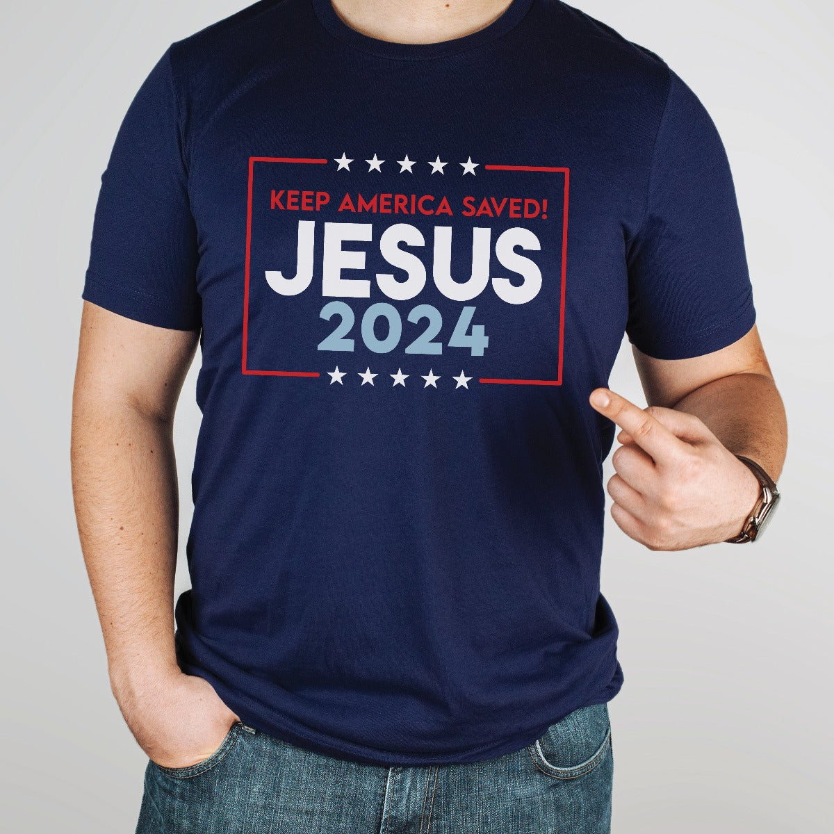 Patriotic man wearing a navy blue stars and stripes Presidential election vote unisex Christian t-shirt, Jesus 2024 Keep America Saved" in bold red, white, and blue fonts, made in the USA, made for men and women God & Country Patriots