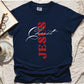 True Navy blue color Christian Comfort Colors 1717 heavyweight unisex t-shirt with faith-based bible typography that says, "Jesus Christ" and white and red letters in the shape of the cross, created for men and women Kingdom believers