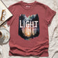 Crimson light dusty red garment dyed Comfort Colors C1717 unisex faith-based Christian t-shirt with "Let the Light In" John 8:12 bible verse and watercolor moody forest trees scene, designed for men and women