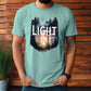 Young trendy man wearing a Seafoam turquoise / light teal garment dyed Comfort Colors C1717 unisex faith-based Christian t-shirt with "Let the Light In" John 8:12 bible verse and watercolor moody forest trees scene, designed for men and women