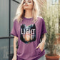 Berry garment dyed Comfort Colors C1717 unisex faith-based Christian t-shirt with "Let the Light In" John 8:12 bible verse and watercolor moody forest trees scene, designed for men and women
