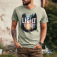 Bearded man wearing Bay light blue / green color garment dyed Comfort Colors C1717 unisex faith-based Christian t-shirt with "Let the Light In" John 8:12 bible verse and watercolor moody forest trees wilderness scene, designed for men and women