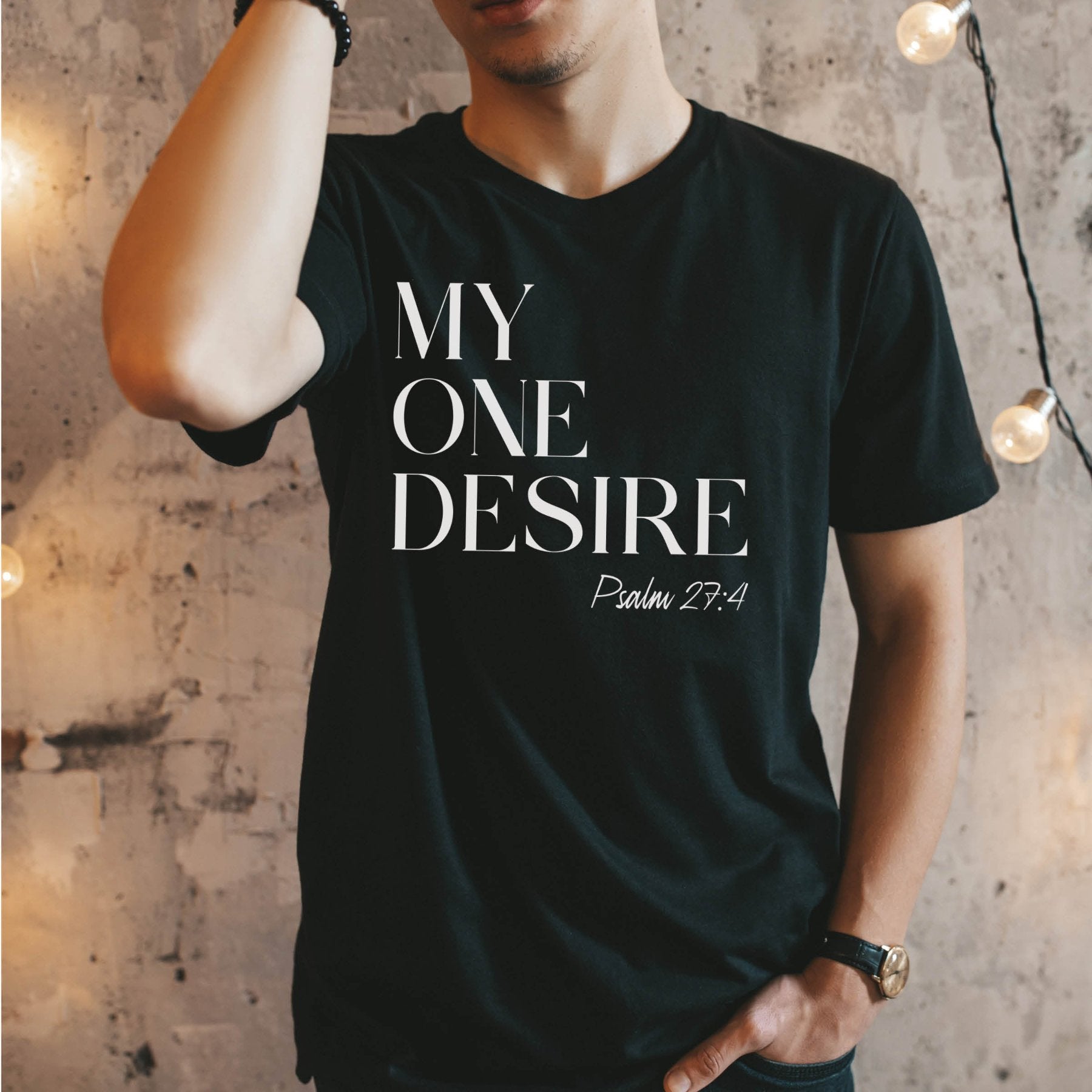Modern man wearing a "My One Desire Psalm 27:4" bible verse black bella canvas 3001 unisex Christian t-shirt designed for men and women