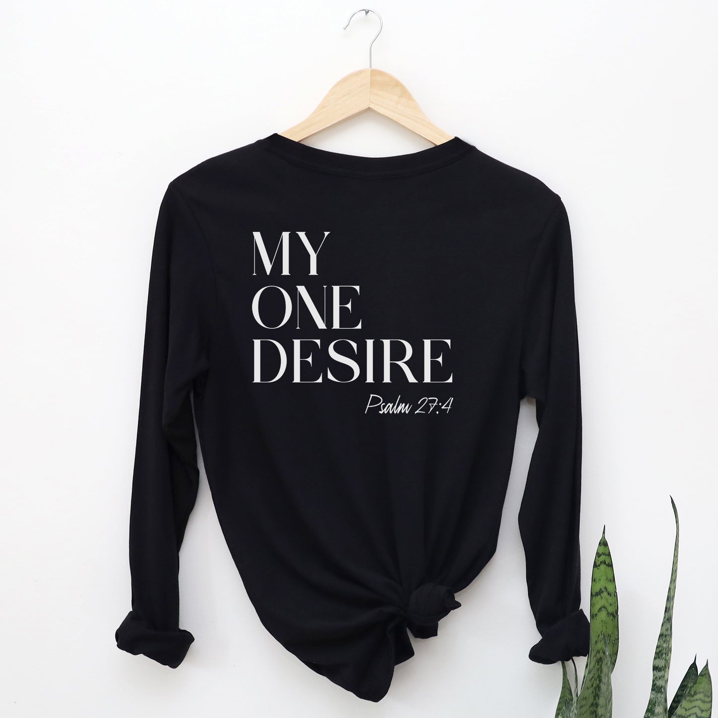 Black cozy soft long sleeve Christian unisex t-shirt with simple modern My One Desire Psalm 27:4 bible verse message printed on front side in white text, designed for both men and women 