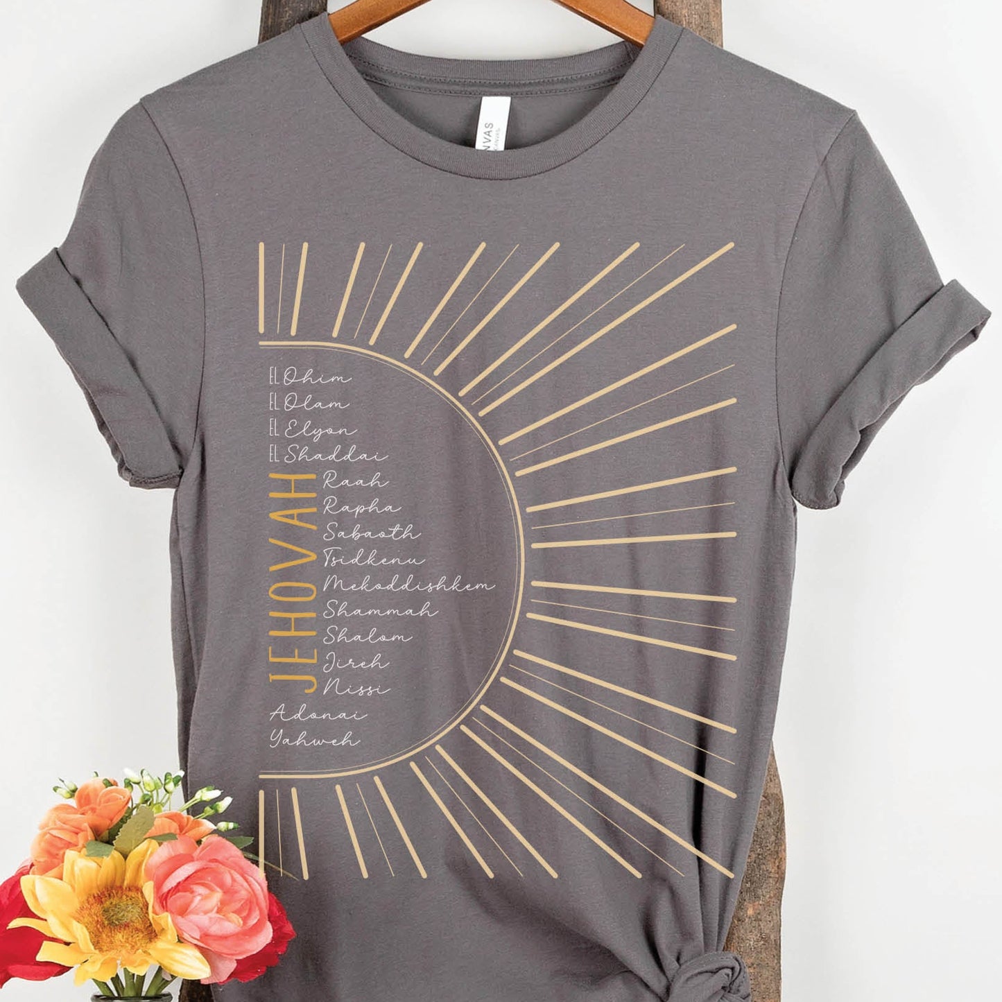 The Names of God Hebrew Christian Old Testament Bible List Sunshine T-Shirt, printed in gold and white on Asphalt Medium Gray Bella-Canvas 3001 t-shirt, women's soft unisex fit regular and plus size tee