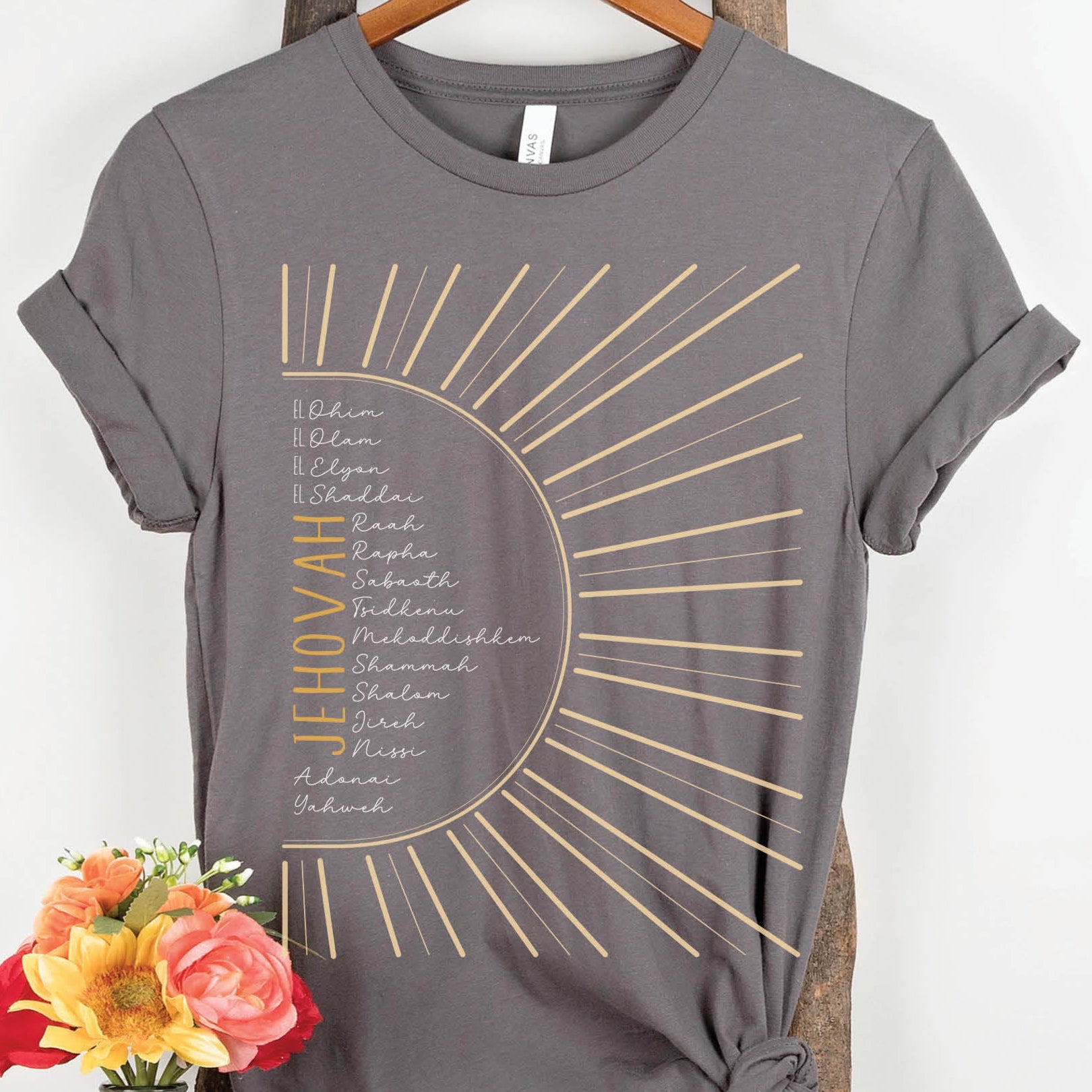 The Names of God Hebrew Christian Old Testament Bible List Sunshine T-Shirt, printed in gold and white on Asphalt Medium Gray Bella-Canvas 3001 t-shirt, women's soft unisex fit regular and plus size tee