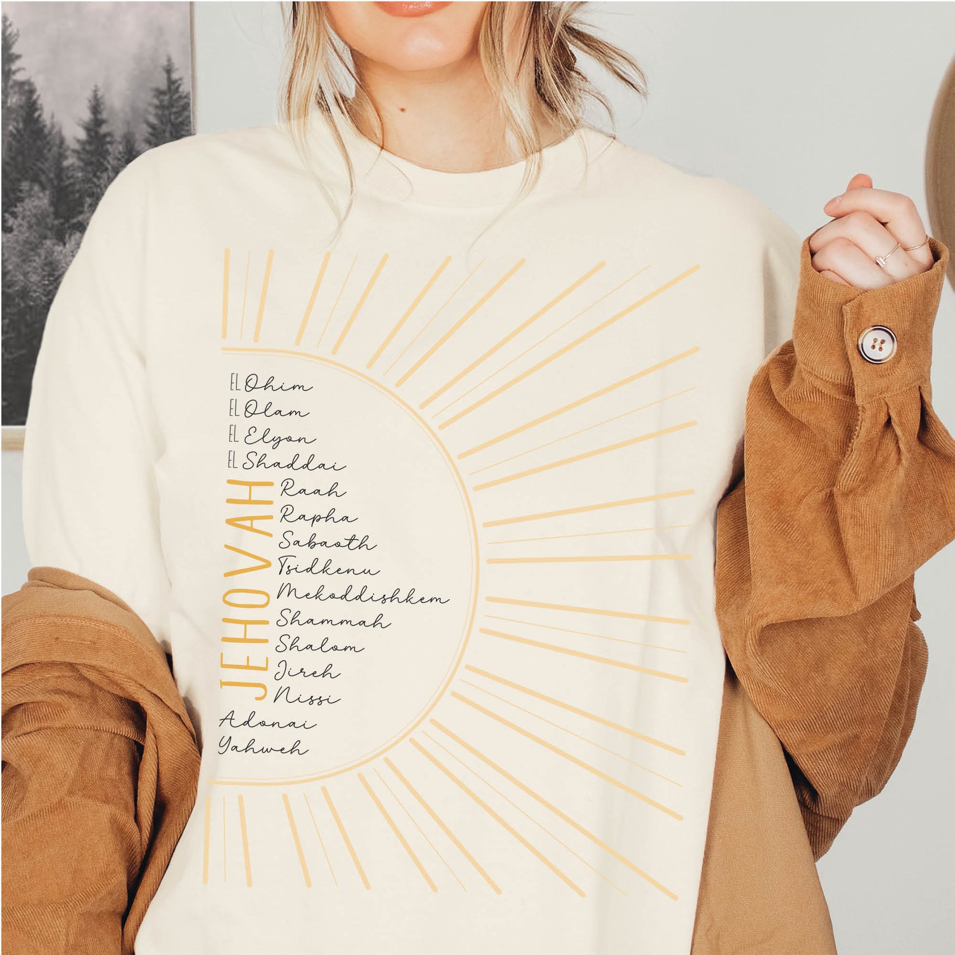 Boho woman wearing The Names of God Hebrew Christian Old Testament Bible List Sunshine T-Shirt, printed in gold and black on soft cream Bella-Canvas 3001 t-shirt, women's soft unisex fit regular and plus size tee