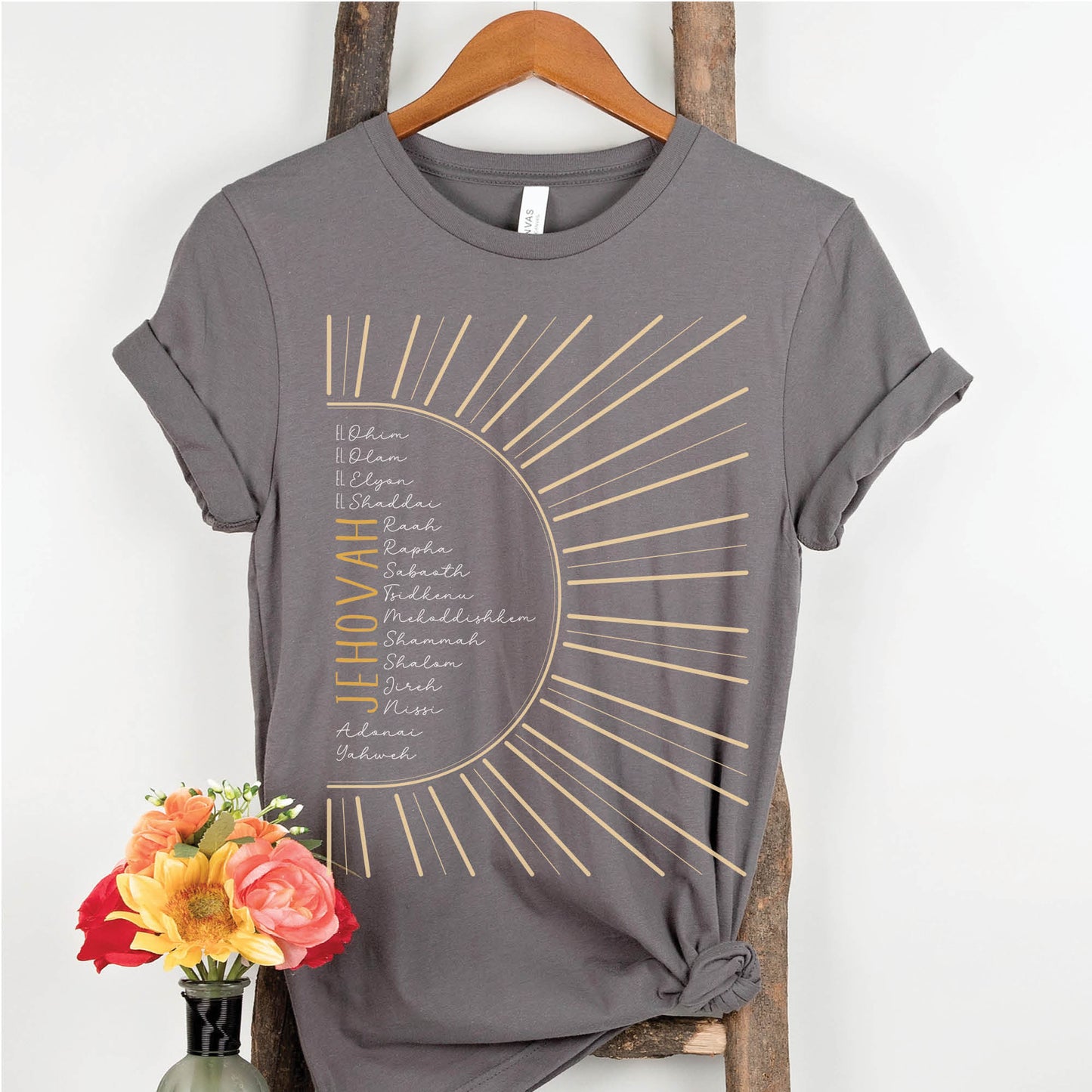 The Names of God Hebrew Christian Old Testament Bible List Sunshine T-Shirt, printed in gold and white on Asphalt Medium Gray Bella-Canvas 3001 t-shirt, women's soft unisex fit regular and plus size tee