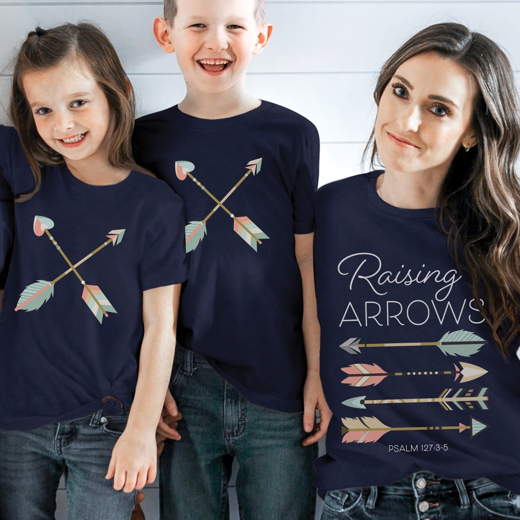 mom, daughter, and son family wearing mommy-and-me navy blue Christian faith-based matching t-shirts with Psalm 127: 4-5 Raising Arrows / Happy Quiver Full scripture boho arrows design for mama and kids