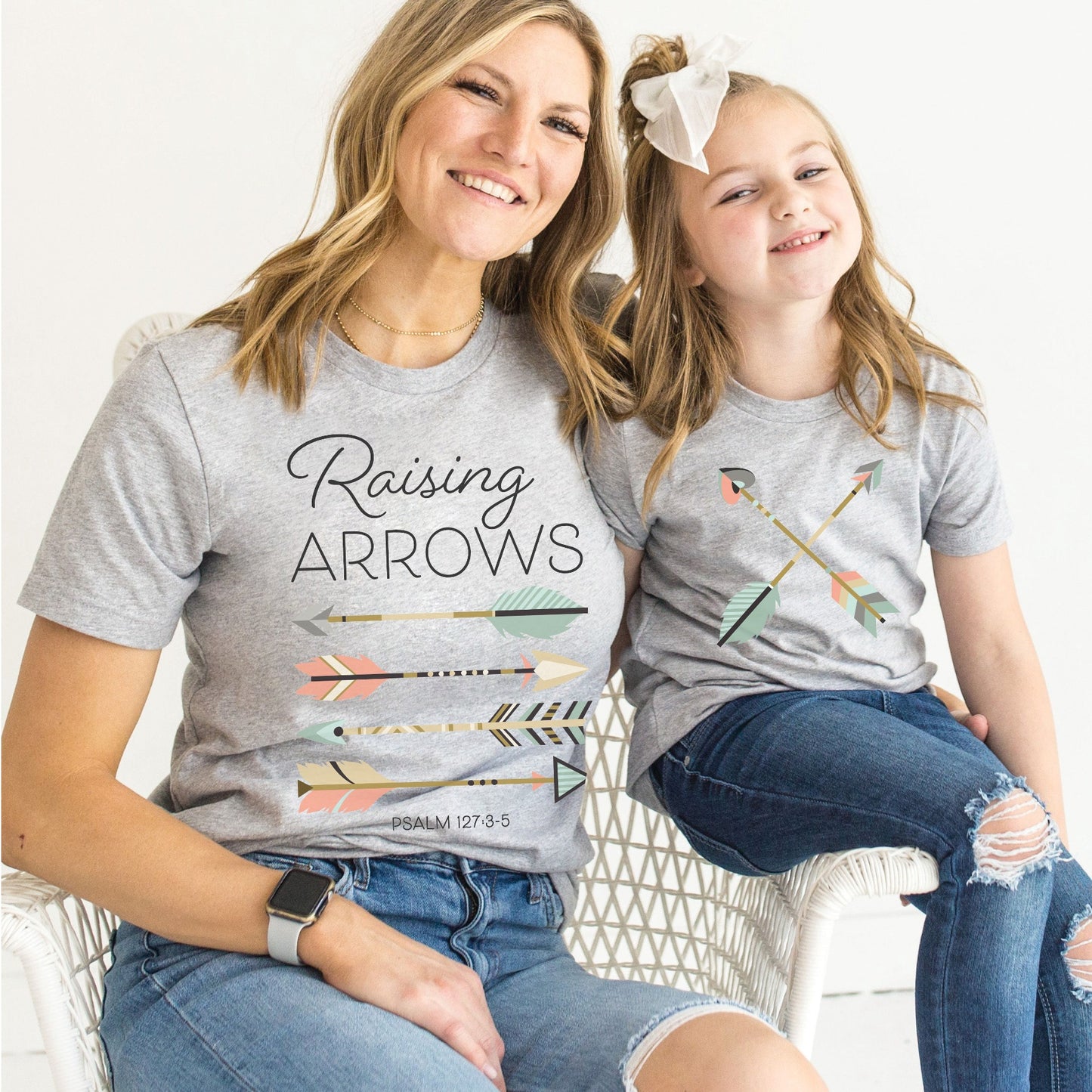 mom and daughter wearing mommy-and-me heather gray Christian faith-based matching t-shirts with Psalm 127: 4-5 Raising Arrows / Happy Quiver Full scripture boho arrows design for moms and kids