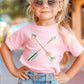 Adorable toddler girl wearing a soft pink kids Christian t-shirt with pastel boho criss-cross arrows for matching mommy-and-me Psalm 127:3-5 Raising a Quiver Full of Arrows bible verse women's tee