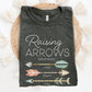 A folded dark heather gray t-shirt with 'Raising Arrows' Psalm 127:3-5 design with 5 personalized names under each arrow and boho accessories on a white background