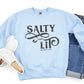Faith-based "Salty And Lit Matthew 5:13-14" bible verse funny Christian aesthetic unisex crewneck sweatshirt with distressed swirl typography design printed in charcoal gray on cozy light blue sweater for women