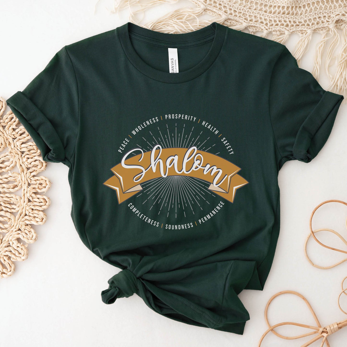 Soft forest dark green faith-based Christian women's unisex t-shirt with a gold banner and sunburst design that says the Biblical Hebrew meaning of the word "SHALOM" - Peace, Completeness, Prosperity, Health, Safety, Wholeness, Soundness, and Permanence definition, makes a great mother's day gift for mom!