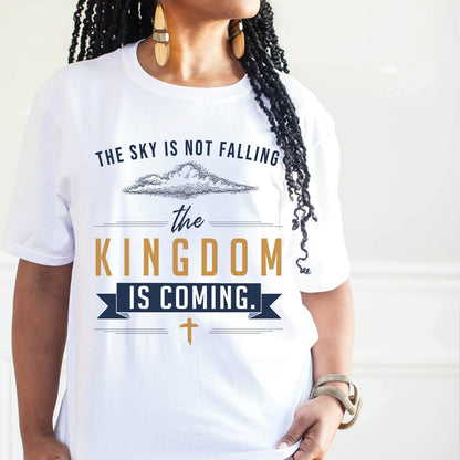 Black woman wearing a unisex t-shirt with a Christian Kingdom of God through Jesus faith-based message that says, "The Sky Is Not Falling, The Kingdom is Coming" with bold font, vintage clouds, banner, and cross design in navy blue and gold, created for bible study Men and Women believers, 2024 eclipse