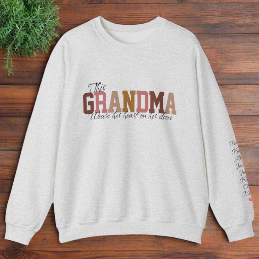 Personalized This GRANDMA Wears Her Heart On Her Sleeve Grandchildren names sleeve print ash gray cozy trendy women's sweatshirt gift for Christmas, birthday or Mother's day