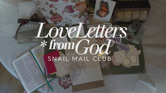 A creative layout showing what's included in the Love  Letters From God Christian snail mail club by Fig & Lily Co. envelope with a personal letter, hand painted bible verse art prints, stickers, beautiful bible journal prompt cards, library cards and vintage paper goodies