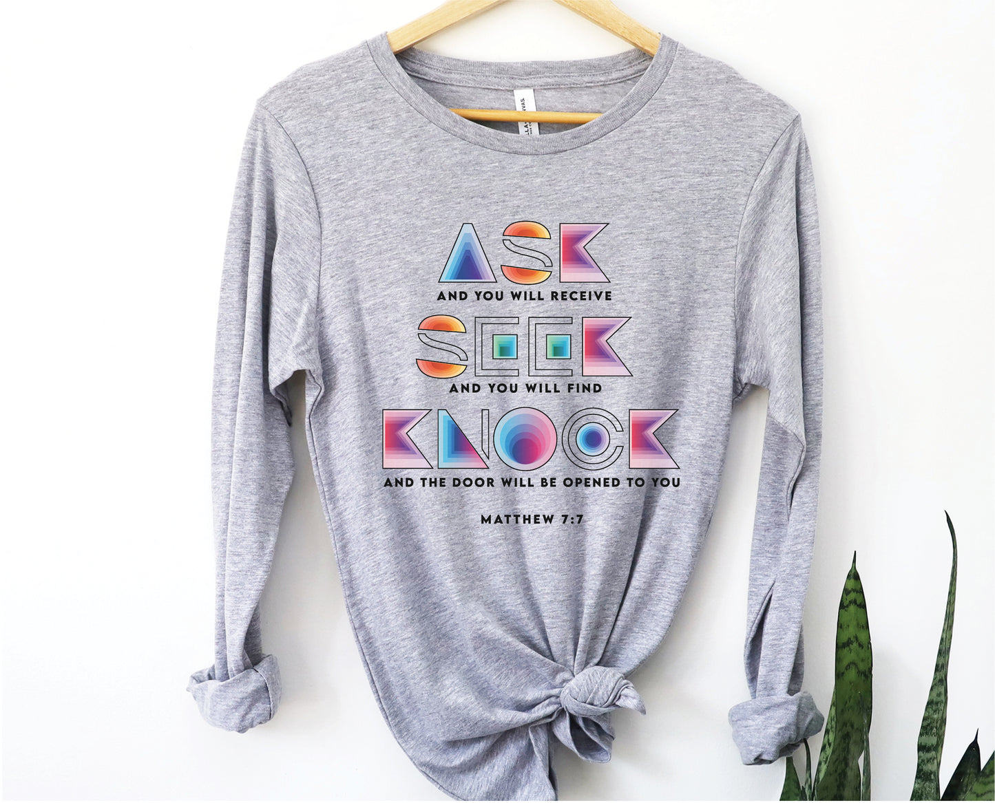 Ask Seek Knock Matthew 7:7 Christian aesthetic design printed in holographic colors on heather gray soft long sleeve tee for men & women