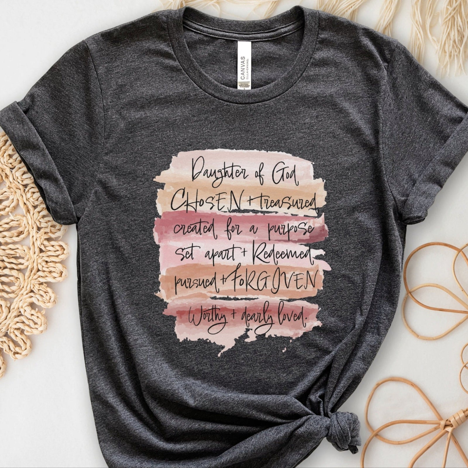 Daughter of God, Chosen, created for a purpose, redeemed, forgiven, worthy, loved, Christian woman aesthetic with neutral colors watercolor splash background printed on soft heather dark gray unisex t-shirt for women