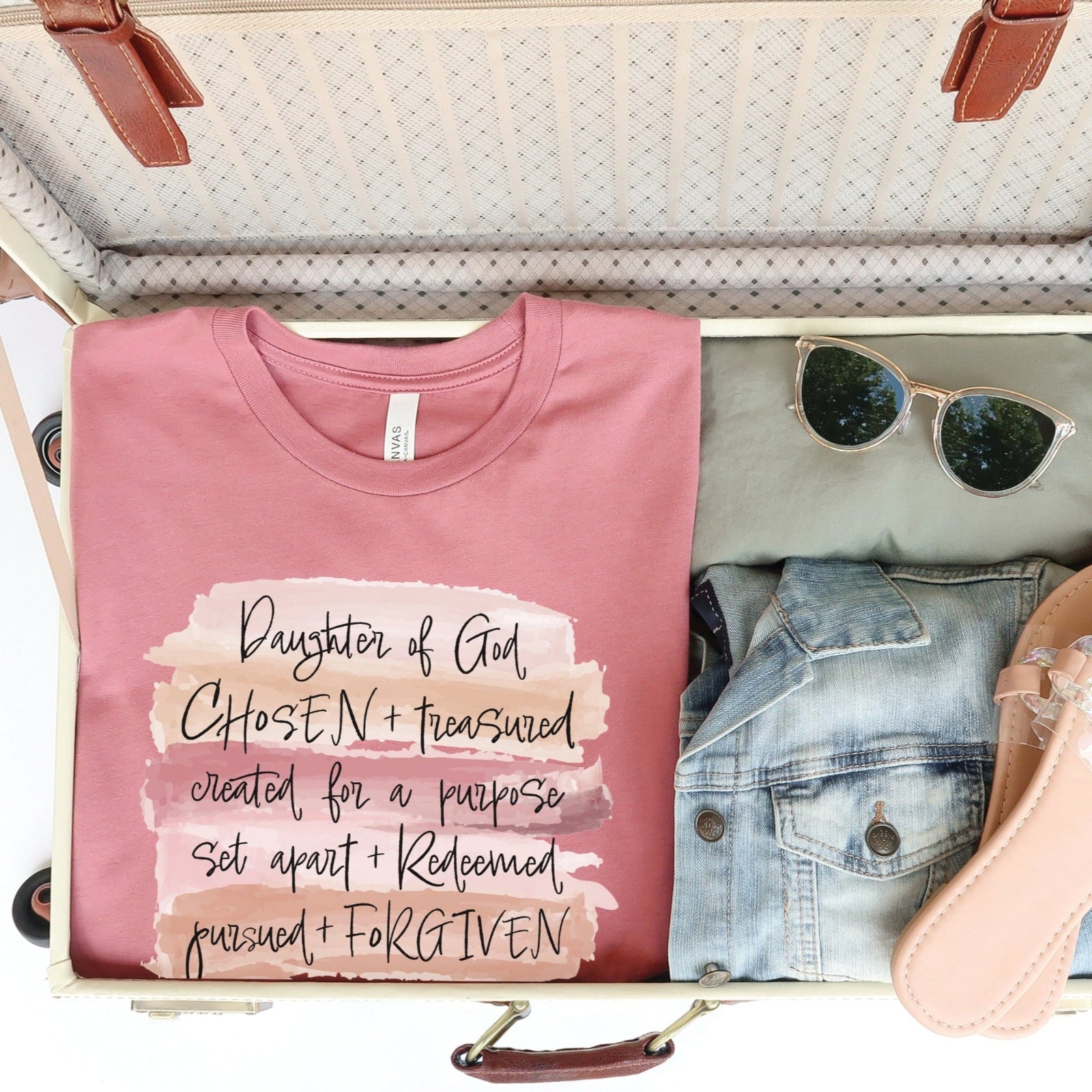 Daughter of God, Chosen, created for a purpose, redeemed, forgiven, worthy, loved, Christian woman aesthetic with neutral colors watercolor splash background printed on mauve pink unisex t-shirt for women