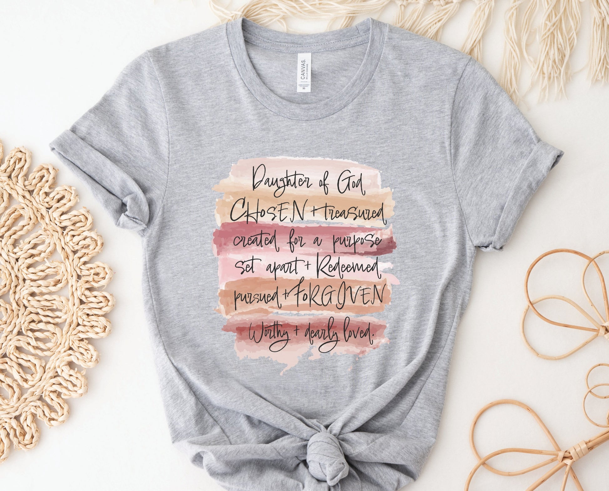 Daughter of God, Chosen, created for a purpose, redeemed, forgiven, worthy, loved, Christian woman aesthetic with neutral colors watercolor splash background printed on soft heather gray unisex t-shirt for women