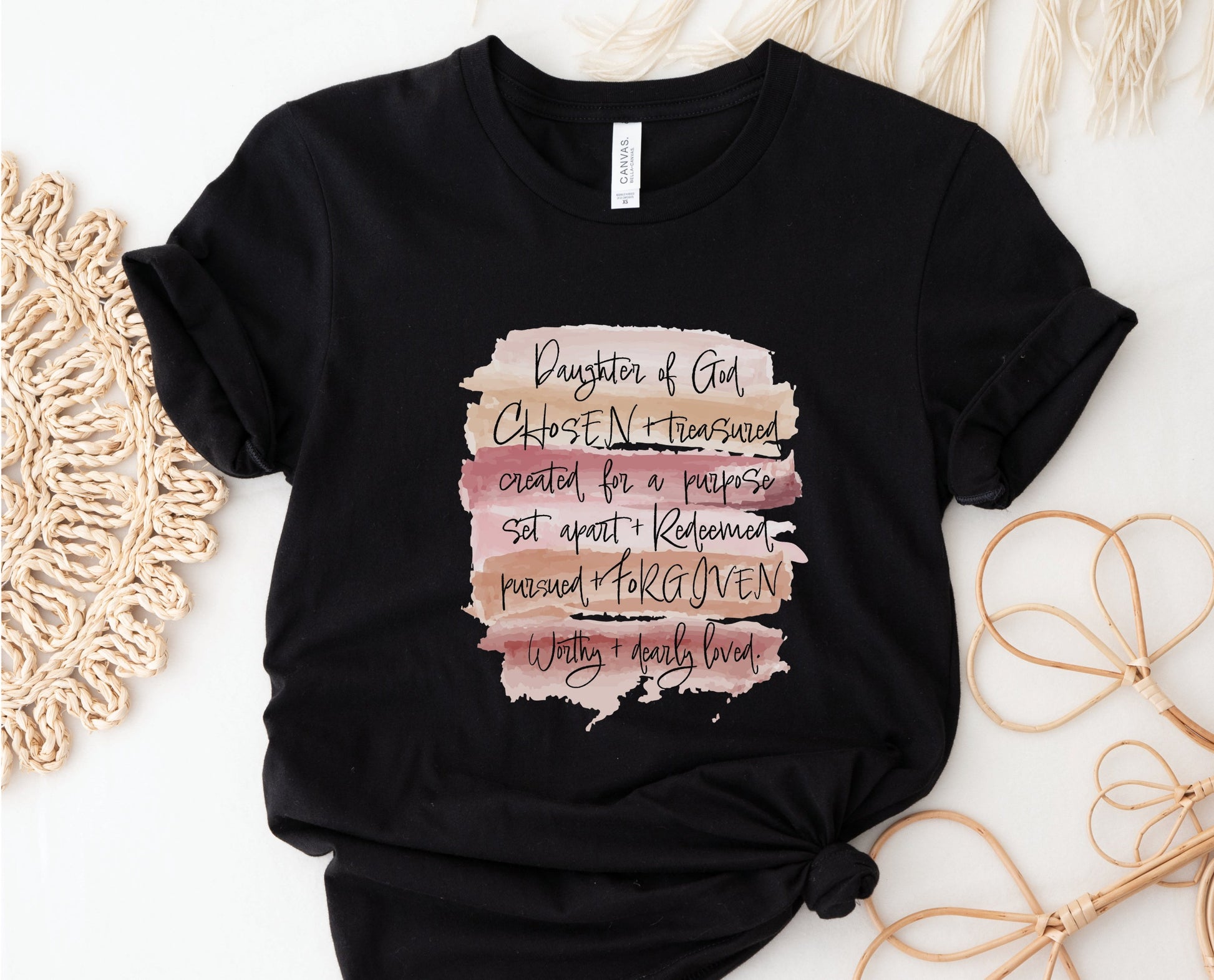 Daughter of God, Chosen, created for a purpose, redeemed, forgiven, worthy, loved, Christian woman aesthetic with neutral colors watercolor splash background printed on soft black unisex t-shirt for women
