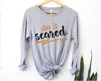 Do It Scared faith over fear 2 Timothy 1:7 do not fear bible verse Christian aesthetic design printed in black and gold on soft heather gray unisex long sleeve tee shirt for women and men