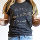 Woman wearing a Heather Dark Gray Christian faith-based unisex t-shirt for women with Micah 6:8 bible verse scripture printed that says, Do Justly Love Mercy walk humbly in gold and white, designed for women in sizes small thru 4X