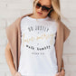 Woman wearing a white Christian aesthetic faith-based unisex t-shirt for women with Micah 6:8 bible verse scripture printed that says, Do Justly Love Mercy walk humbly, in gold and black, unique gift for her