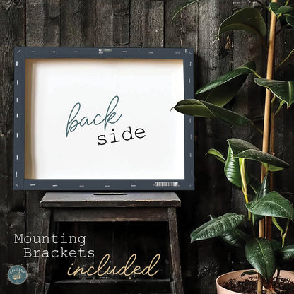 A photo of a Jeremiah 29:11 bible verse canvas print, showing how it is hand stretched and wrapped around the back side with mounting bracket hardware included, inspirational wall art for home, church, or office decor