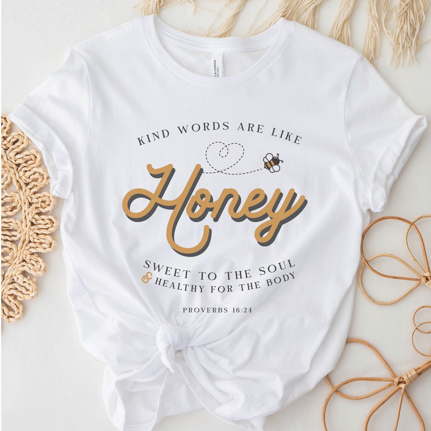 White and gold Christian aesthetic unisex faith-based kindness bee t-shirt for women with Proverbs 16:24 bible verse quote that says, "Kind Words Are Like Honey, Sweet To the Soul, and Healthy For the Body" 