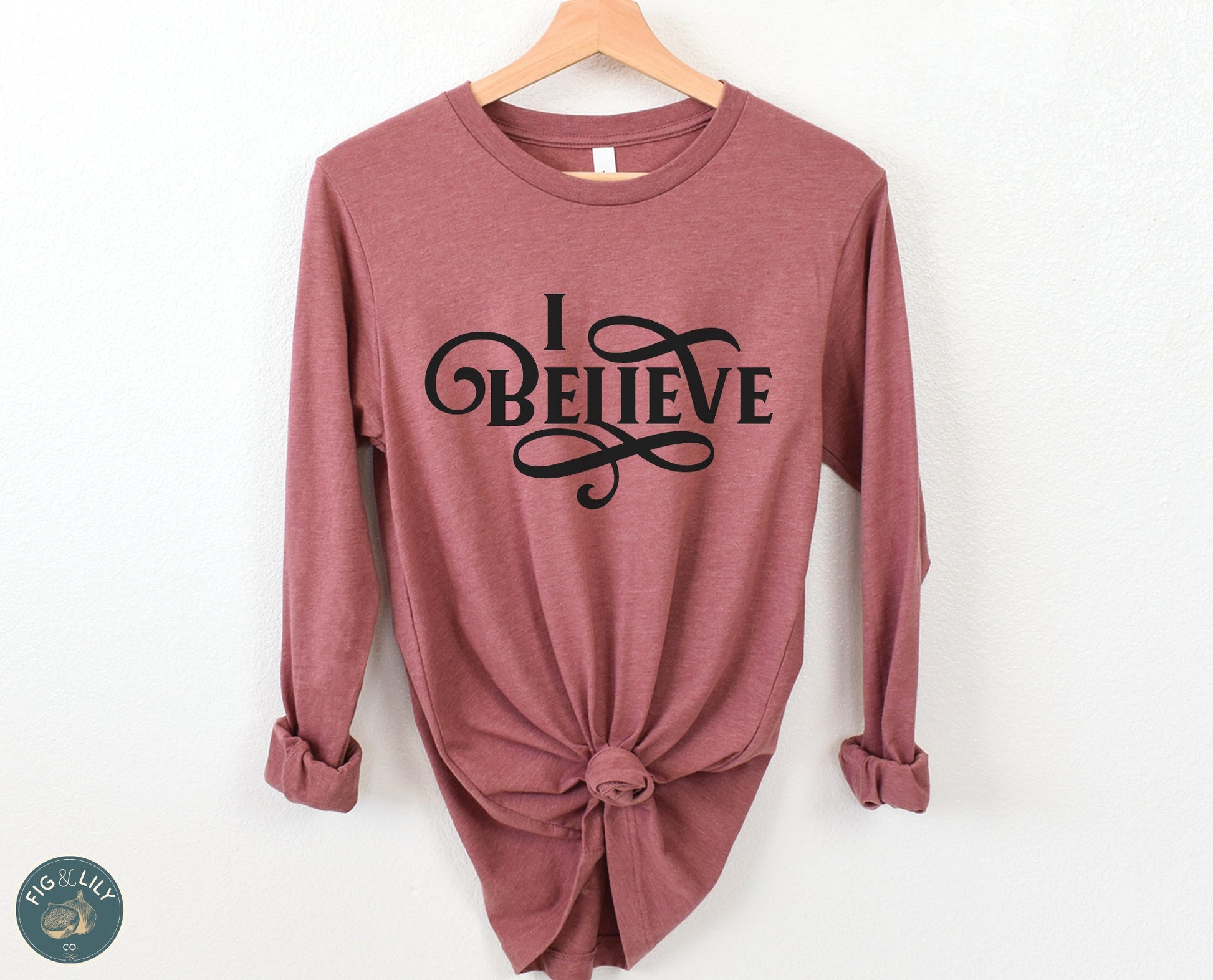 I Believe Swirl Christian aesthetic faith statement design printed in black on soft heather mauve dusty rose long sleeve tee for women