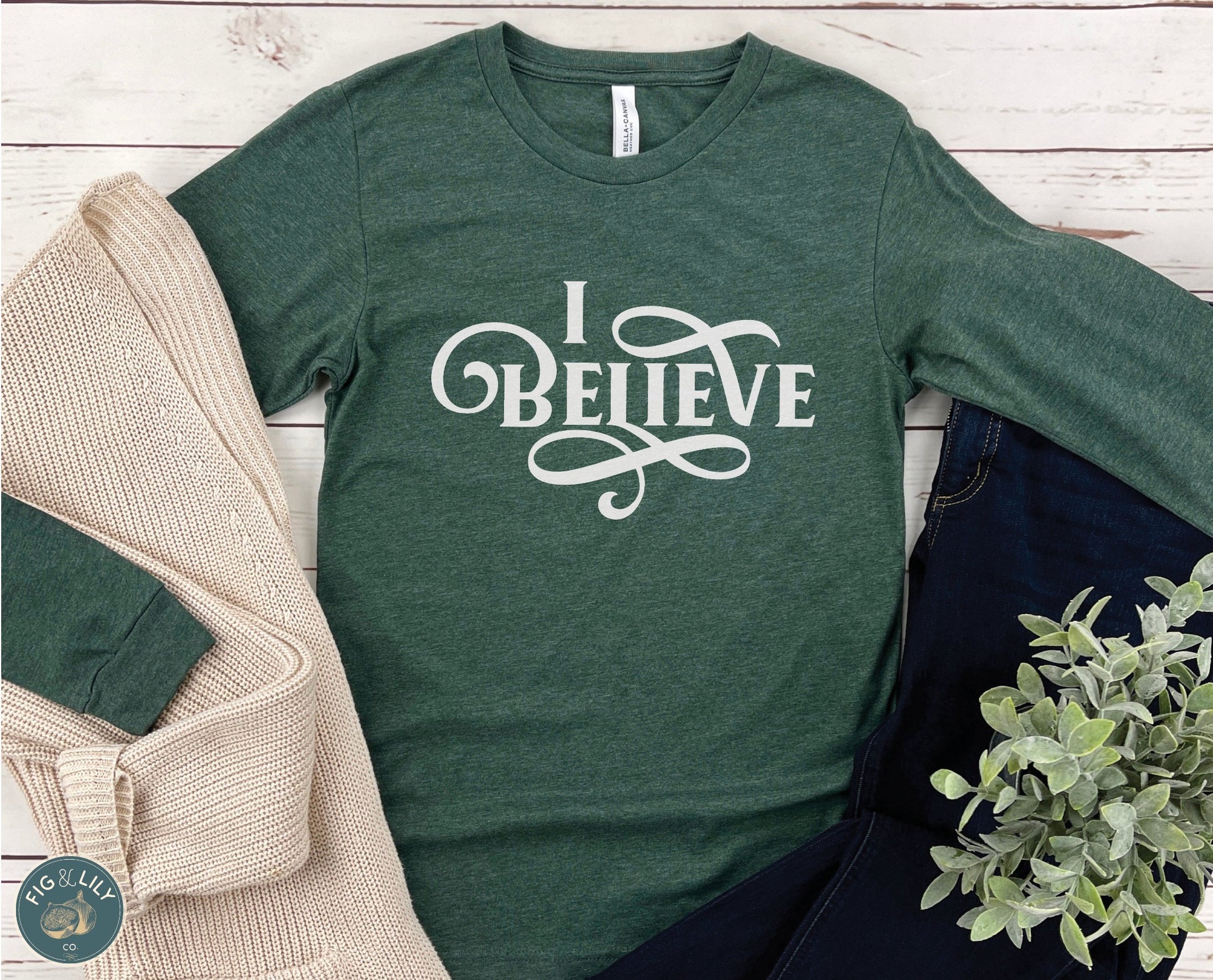 I Believe Swirl Christian aesthetic Jesus believer design printed in white on soft heather forest green long sleeve tee for women