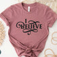 I Believe Swirl Christian aesthetic Jesus believer t-shirt design printed in black on soft mauve dusty rose tee for women, great gift for her