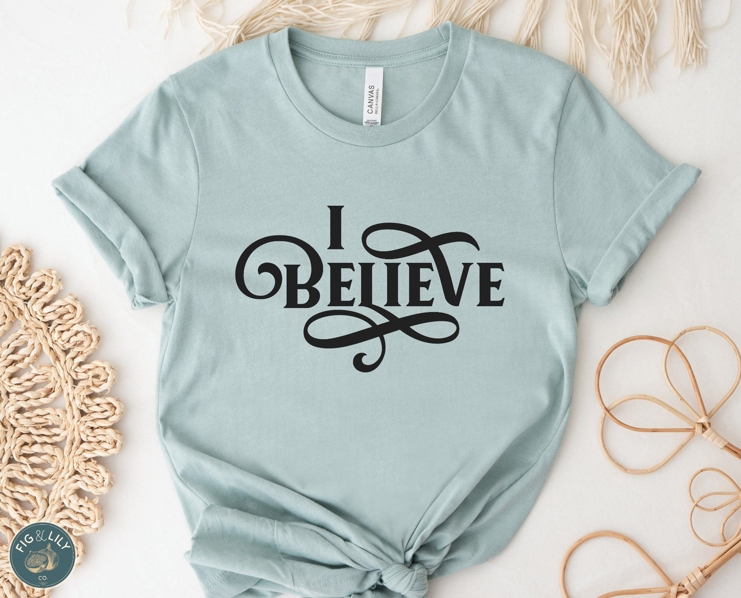 I Believe Swirl Christian aesthetic Jesus believer t-shirt design printed in black on soft heather dusty blue tee for women, great gift for her
