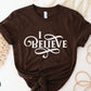 I Believe Swirl Christian aesthetic Jesus believer t-shirt design printed in white on soft chocolate brown tee for women, great gift for her