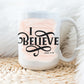 I Believe Swirl faith based Christian aesthetic John 9 bible verse peach pink watercolor splash background printed on white 15 oz. sturdy ceramic mug
