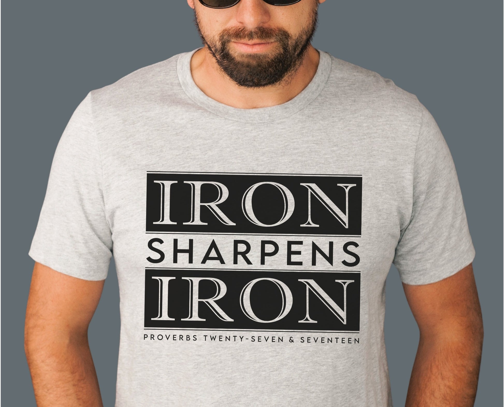 Iron Sharpens Iron Proverbs 27:17 Christian aesthetic block style design printed in black on soft heather gray unisex t-shirt for men's groups