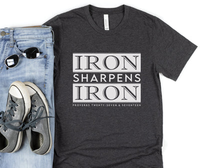 Iron Sharpens Iron Proverbs 27:17 Christian aesthetic block style design printed in white on soft heather dark gray unisex t-shirt for men's groups