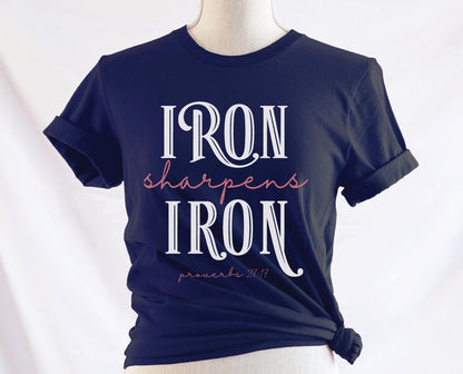 Iron Sharpens Iron Proverbs 27:17 Christian aesthetic design printed in white and mauve on ladies soft navy blue unisex t-shirt for women's groups