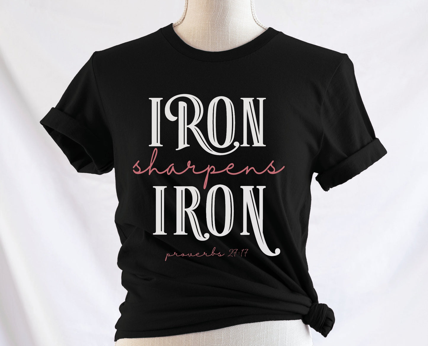 Iron Sharpens Iron Proverbs 27:17 Christian aesthetic design printed in white and mauve on ladies soft black unisex t-shirt for women's groups