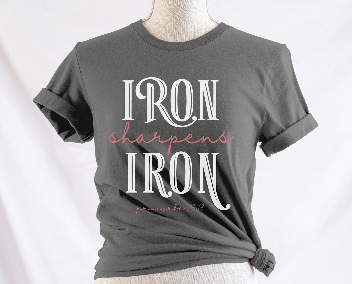 Iron Sharpens Iron Proverbs 27:17 Christian aesthetic design printed in white and mauve on ladies soft asphalt gray unisex t-shirt for women's groups