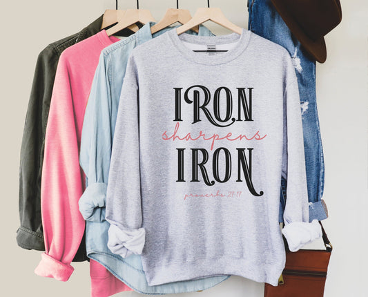 Iron Sharpens Iron Proverbs 27:17 Christian aesthetic design printed in black and mauve on cozy heather gray unisex crewneck sweatshirt for women's groups
