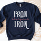 Iron Sharpens Iron Proverbs 27:17 Christian aesthetic design printed in white and mauve on cozy navy blue unisex crewneck sweatshirt for women's groups