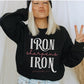 Iron Sharpens Iron Proverbs 27:17 Christian aesthetic design printed in white and mauve on cozy black unisex crewneck sweatshirt for women's groups
