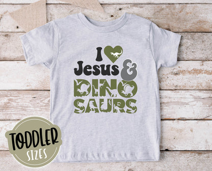 I Love Jesus and Dinosaurs cute Christian aesthetic soft toddler size kids t-shirt for boys in white, black, heather gray, and navy blue