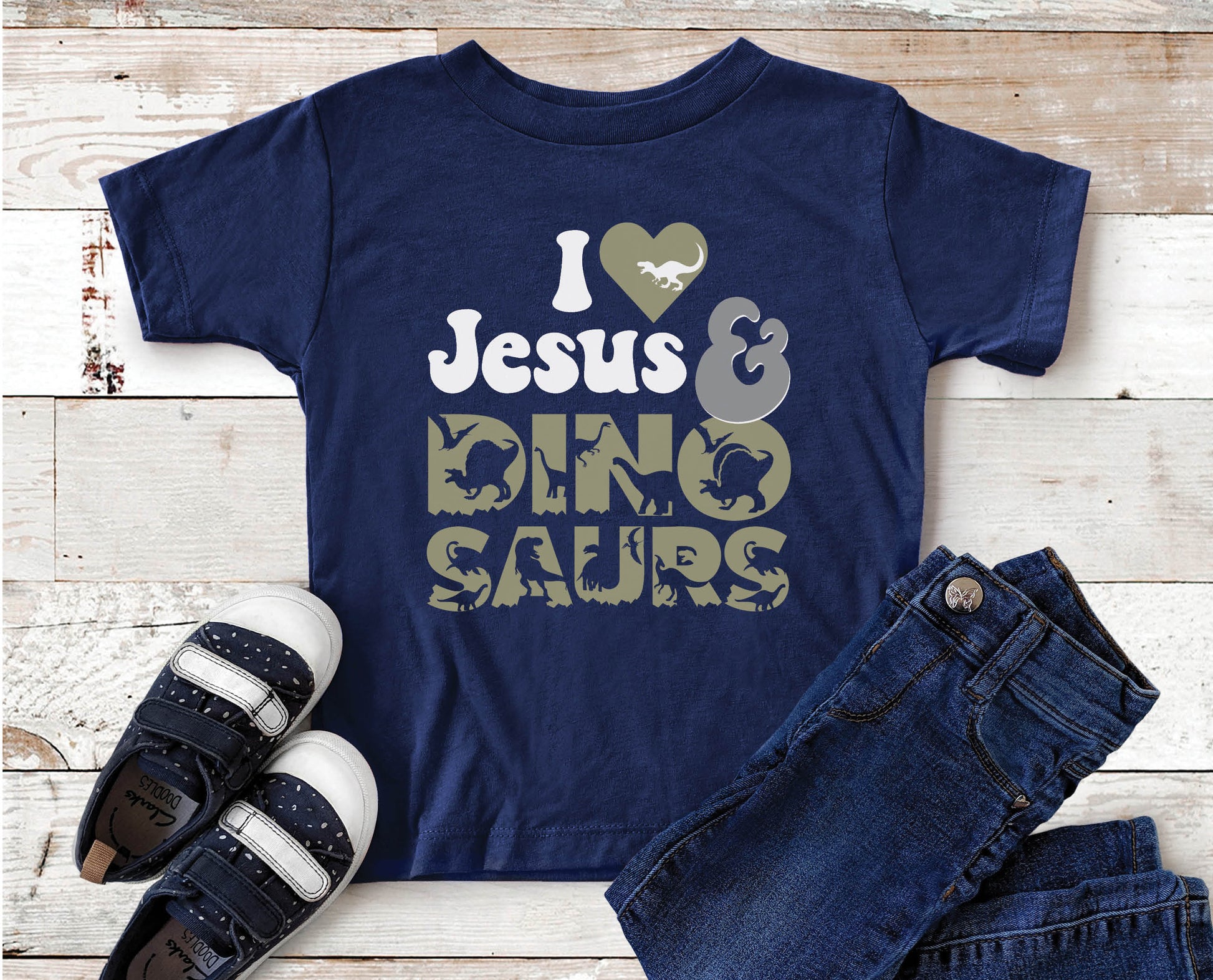 I Love Jesus and Dinosaurs cute Christian aesthetic soft toddler size kids t-shirt for boys in white, black, heather gray, and navy blue